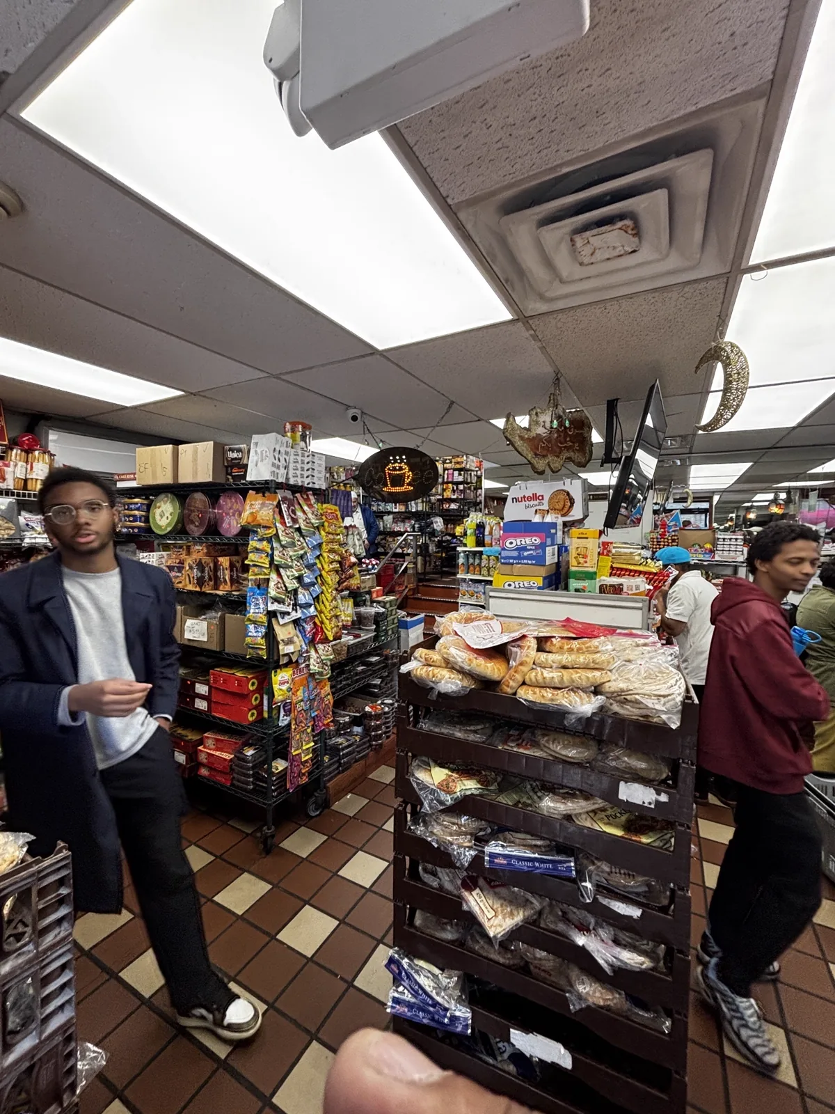 Front bakery counter with display rack of breads and pastries