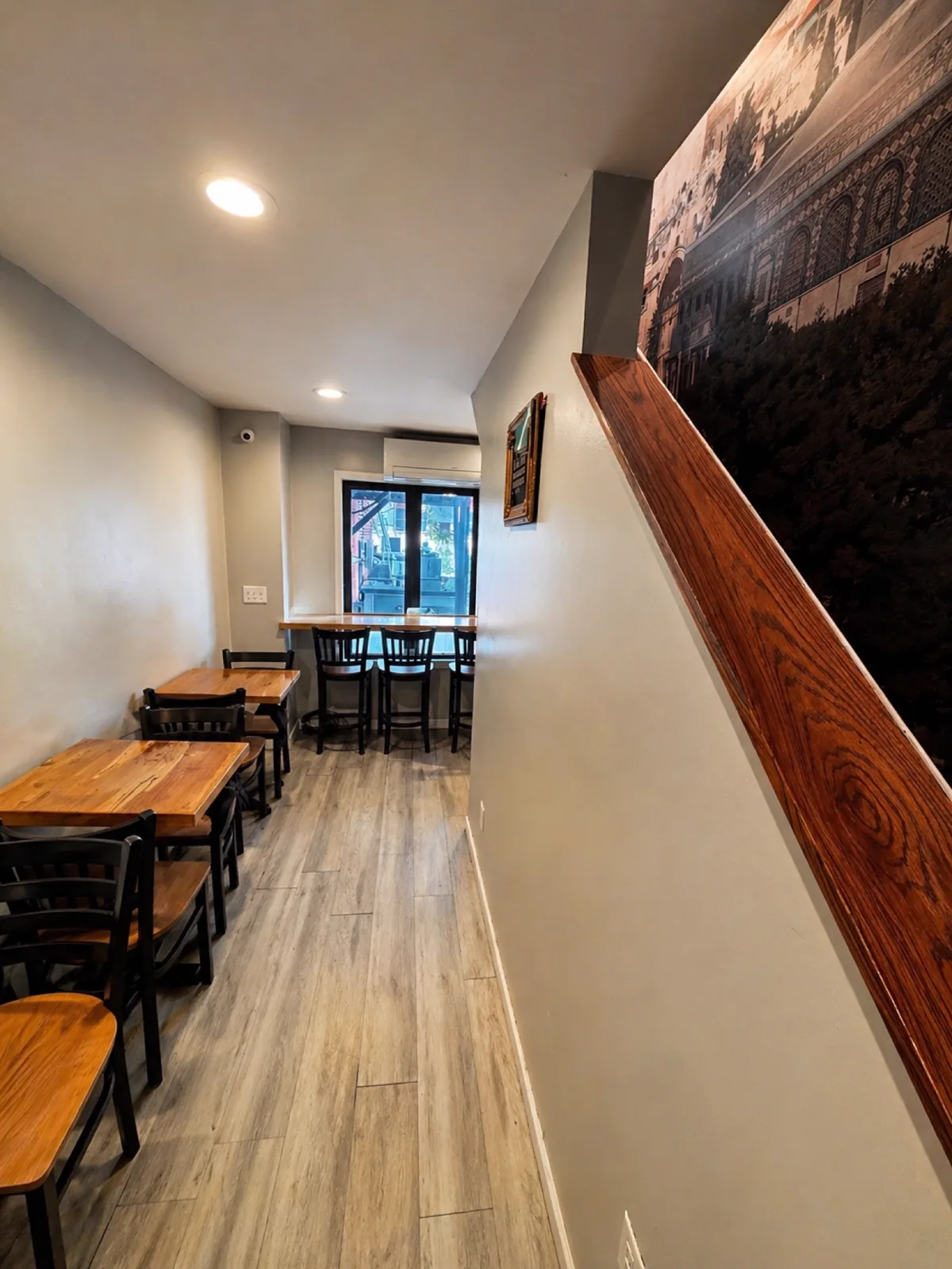 Wooden café tables and chairs in the dining room at Makkah Market