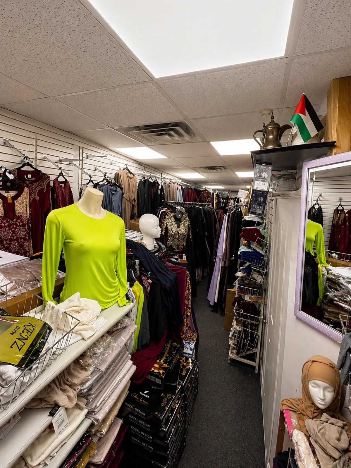 Clothing rack with mannequins and dresses inside the Makkah Market bazaar