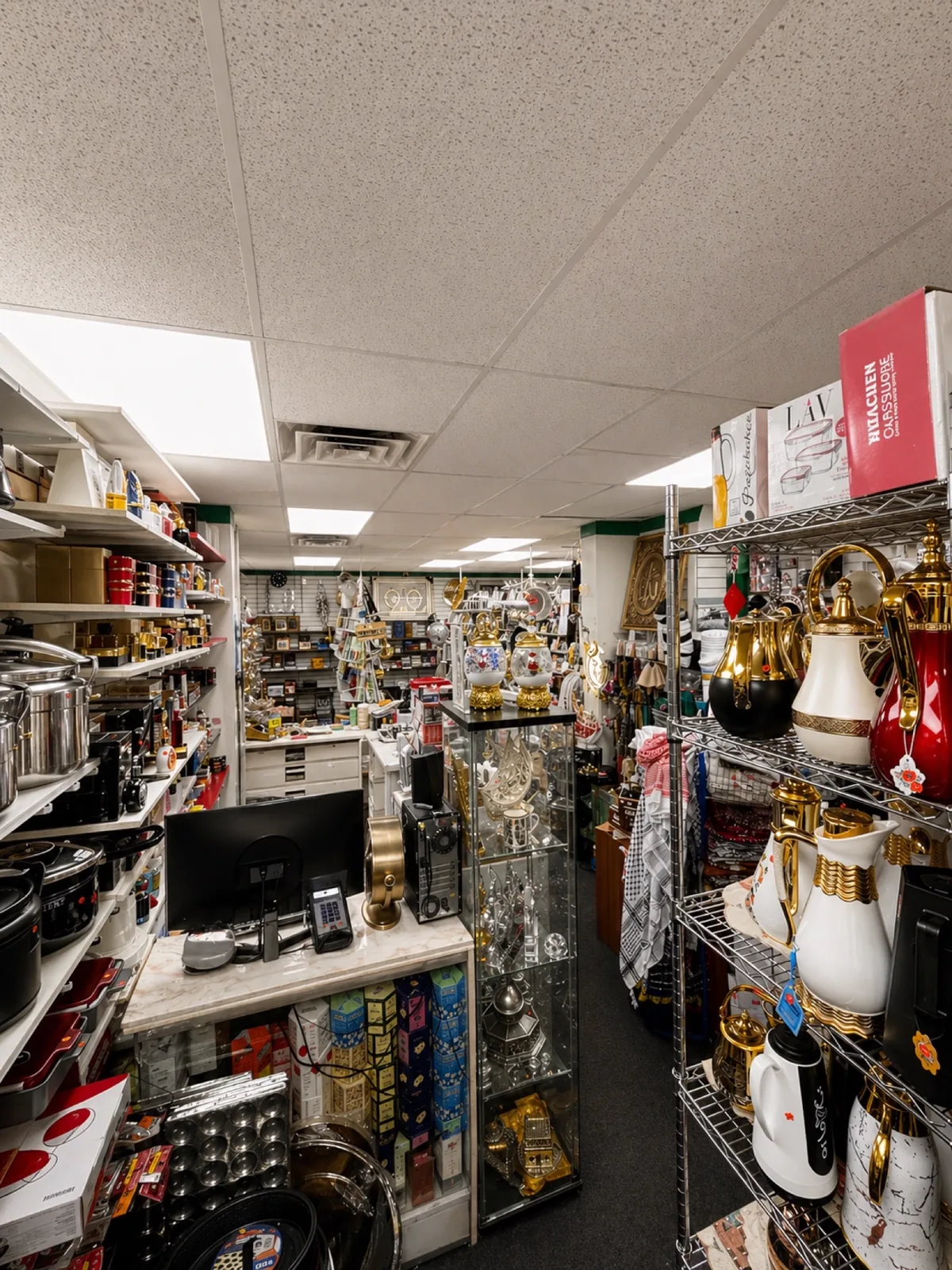 Shelf of brass teapots, copper kettles, samovars and gift items in the bazaar