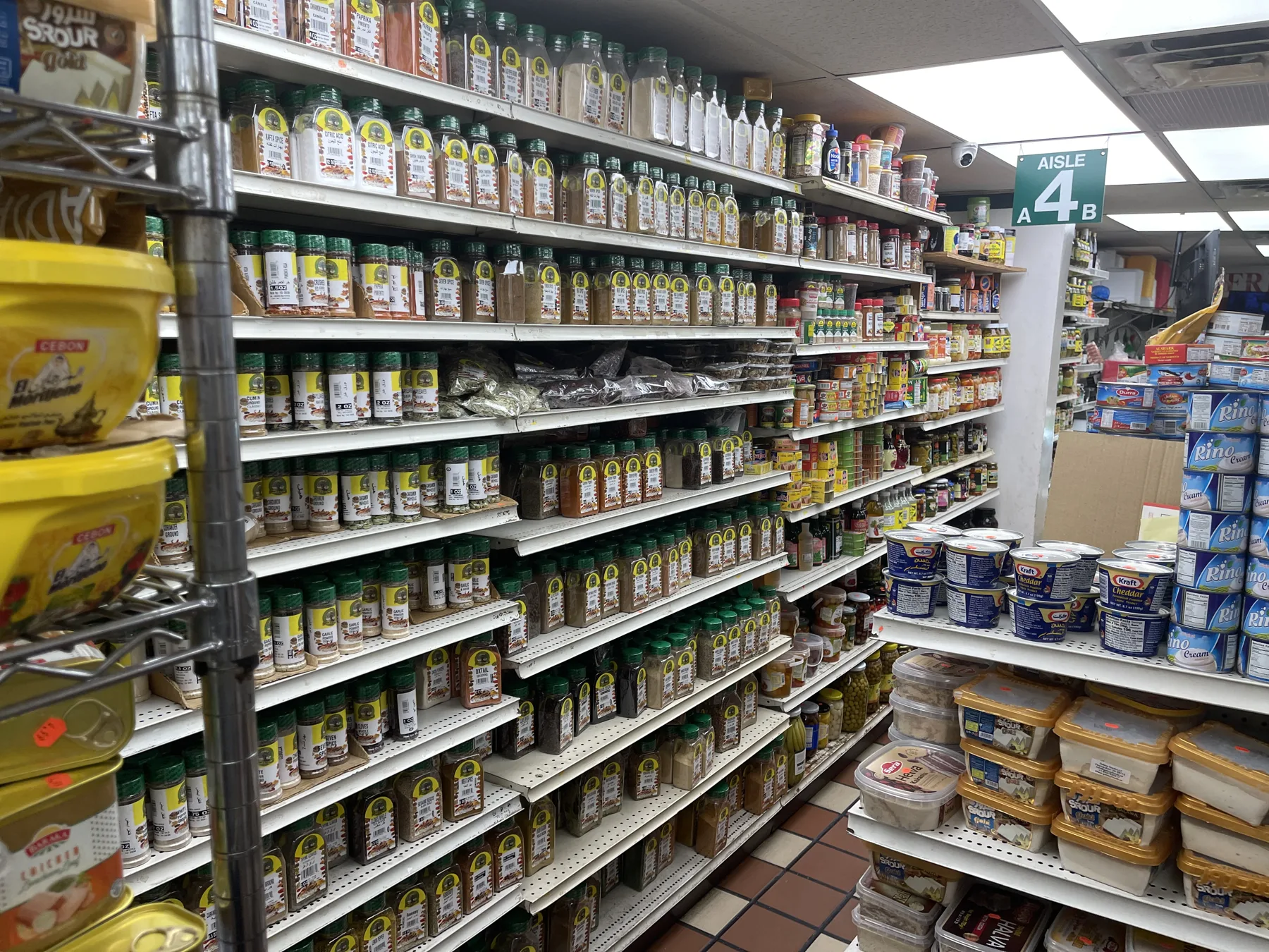 Middle Eastern grocery shelves at Makkah Market — spices, condiments and pantry staples in West Philadelphia