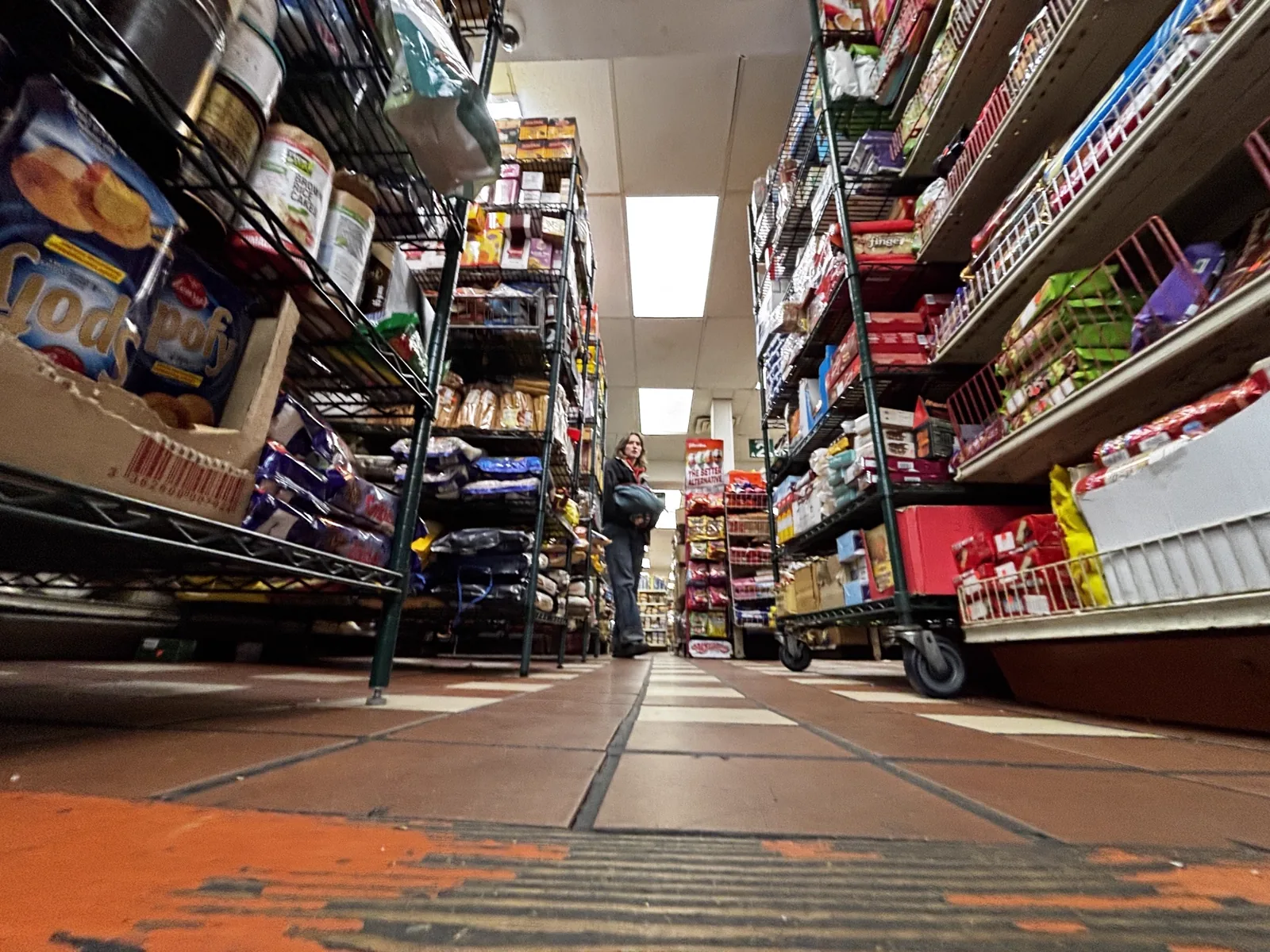Low-angle view of pantry aisle stacked with cooking essentials