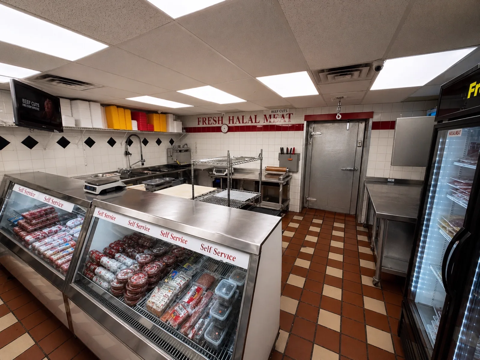 Halal meat counter at Makkah Market with staff and self-service display