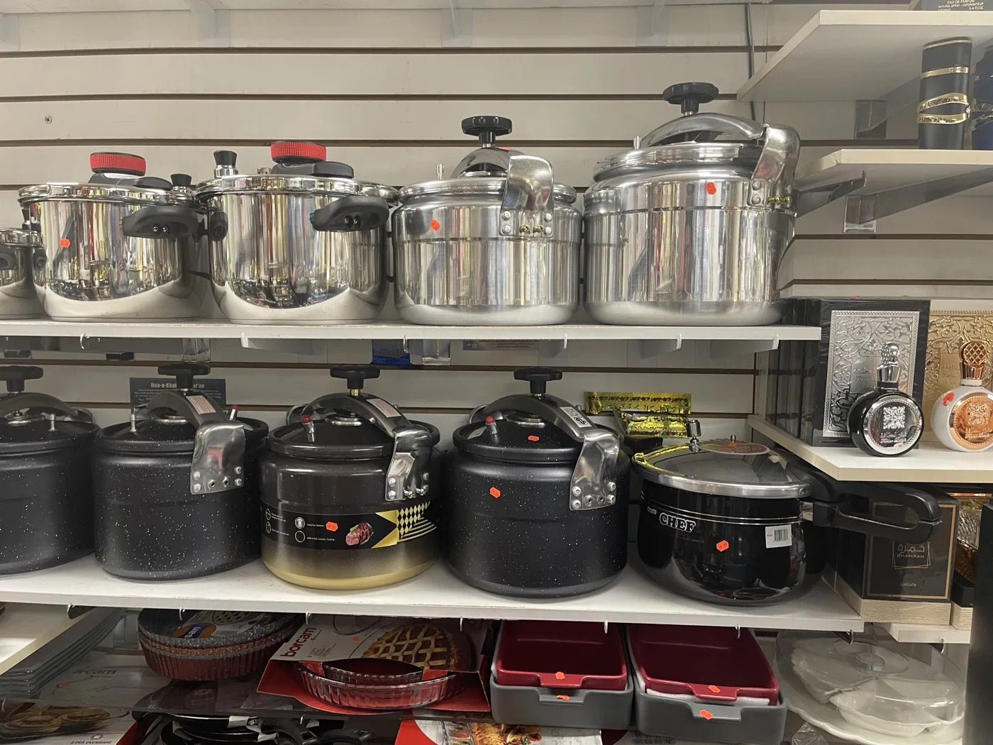 Houseware at the Makkah Market upstairs bazaar — shelves of cooking pots and pressure cookers in West Philadelphia