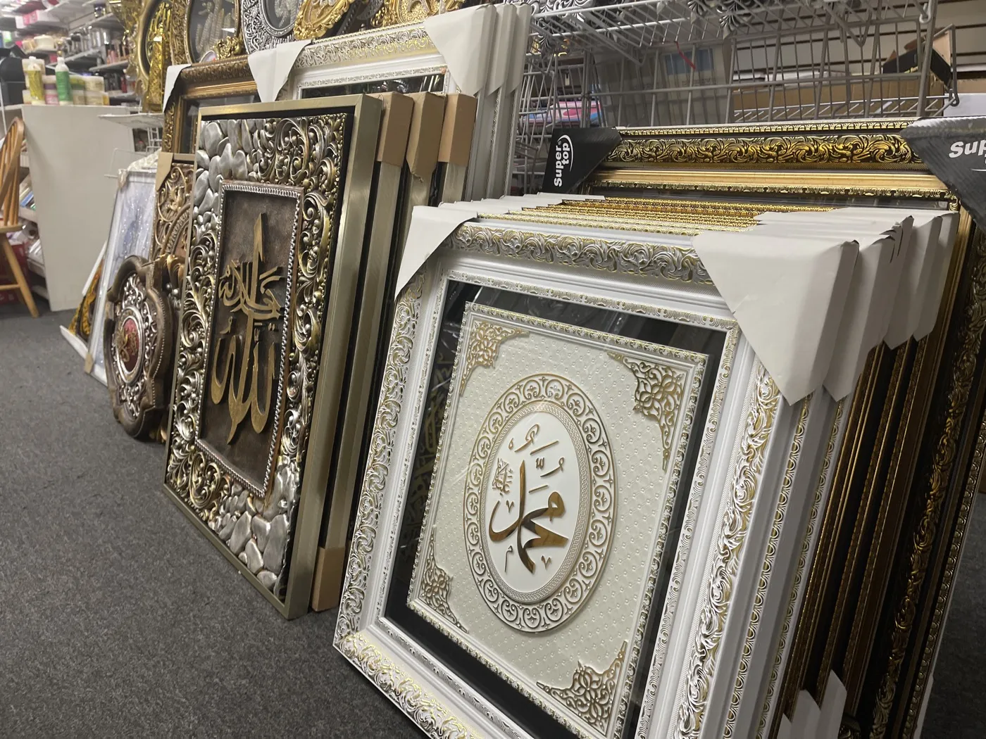 Framed Quranic calligraphy signs and wall art at the Makkah Market upstairs bazaar in West Philadelphia