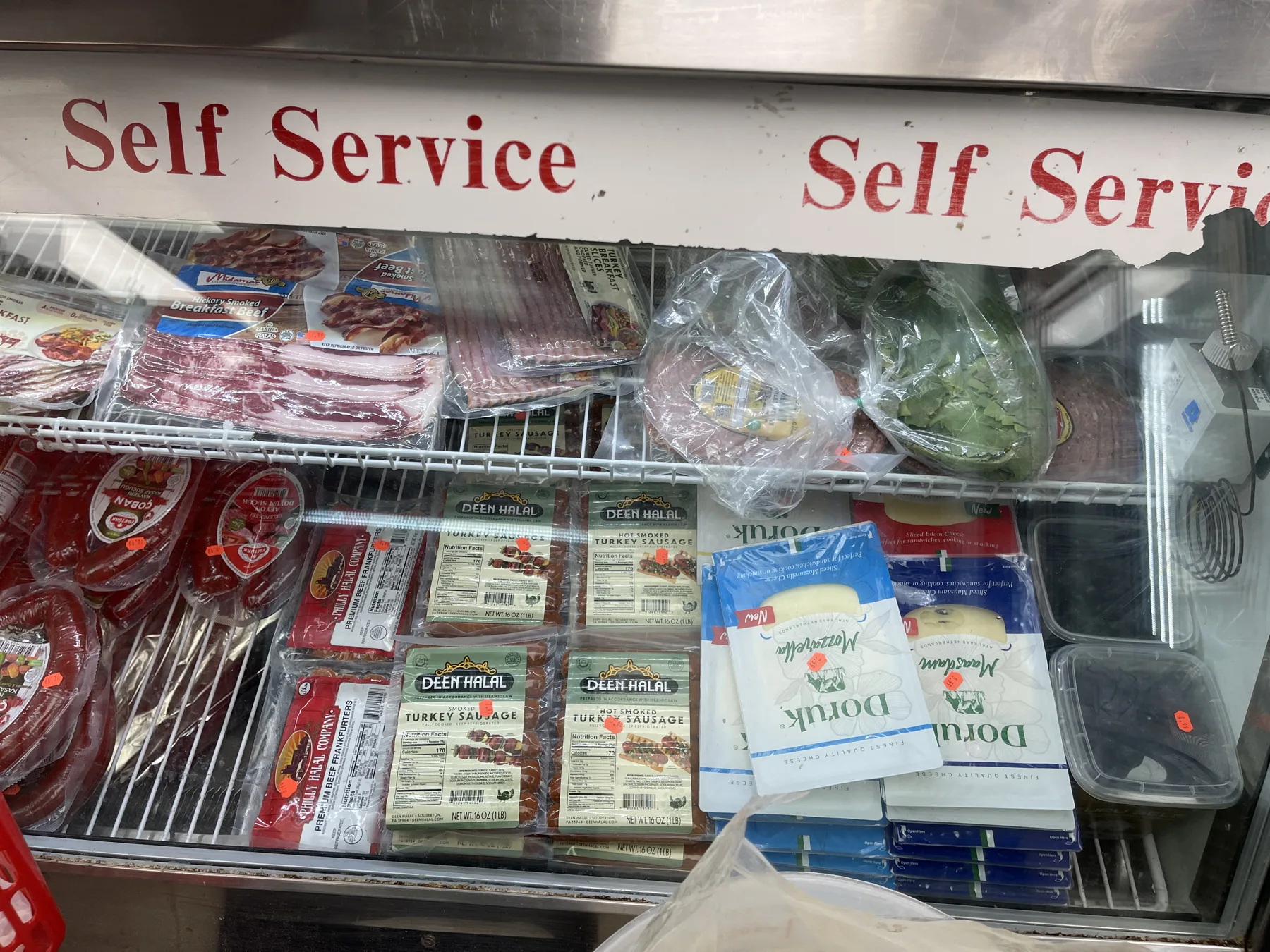 Self-service deli case with Doruk mozzarella, halal beef sausage and cold cuts at Makkah Market