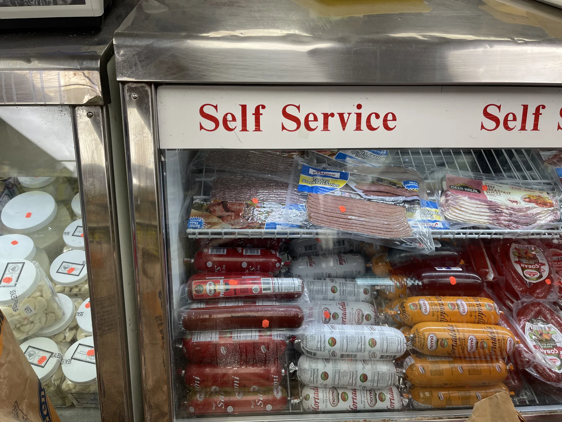 Self-service deli case with halal sausages, sujuk and merguez at Makkah Market in West Philadelphia