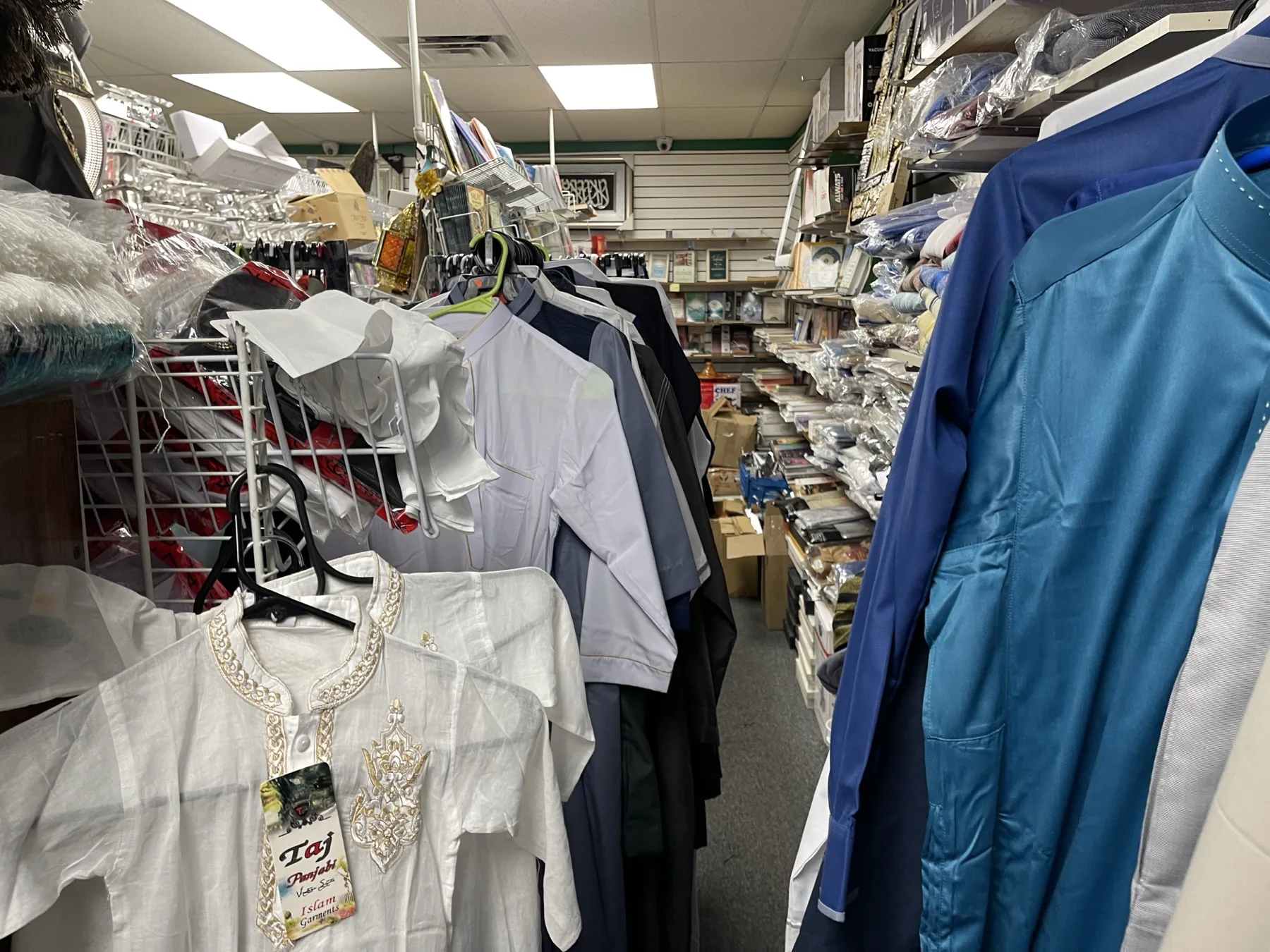 Men's Islamic garments — thobes and traditional clothing hanging in the upstairs bazaar at Makkah Market, West Philadelphia